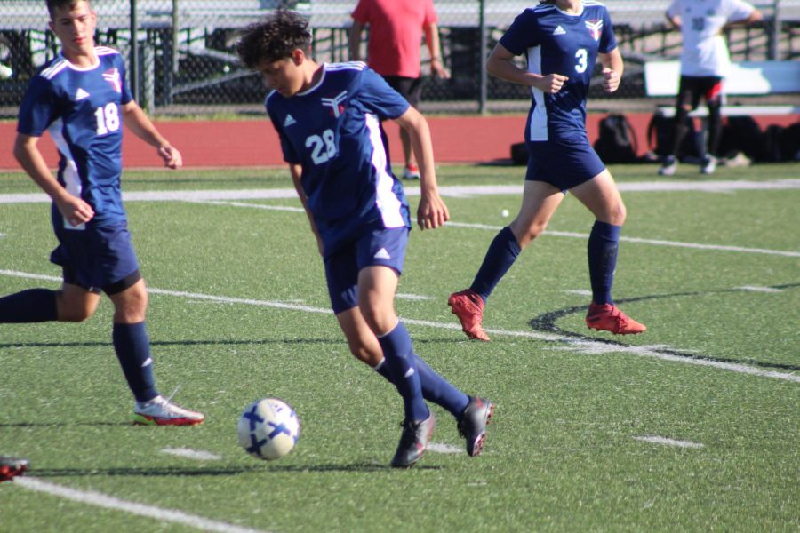 Soccer player, Marco Rodriquez, moving the ball down the field