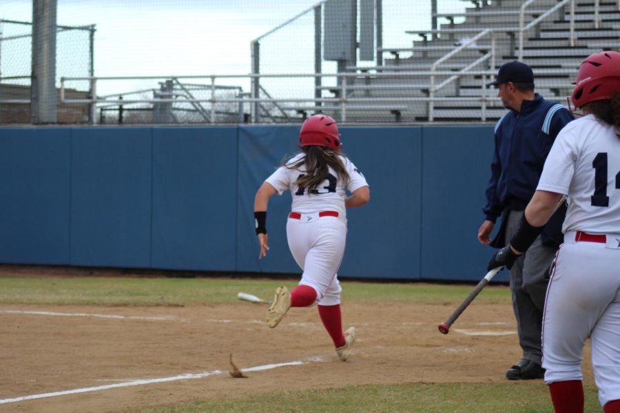 Running to home plate to score for the Lady Falcons