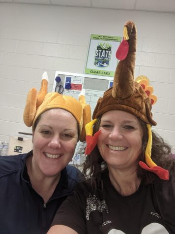Coach Prince and Roberts wearing their turkey hats for Aquatics