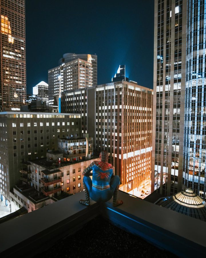 Spiderman+looking+out+over+the+city+at+night.